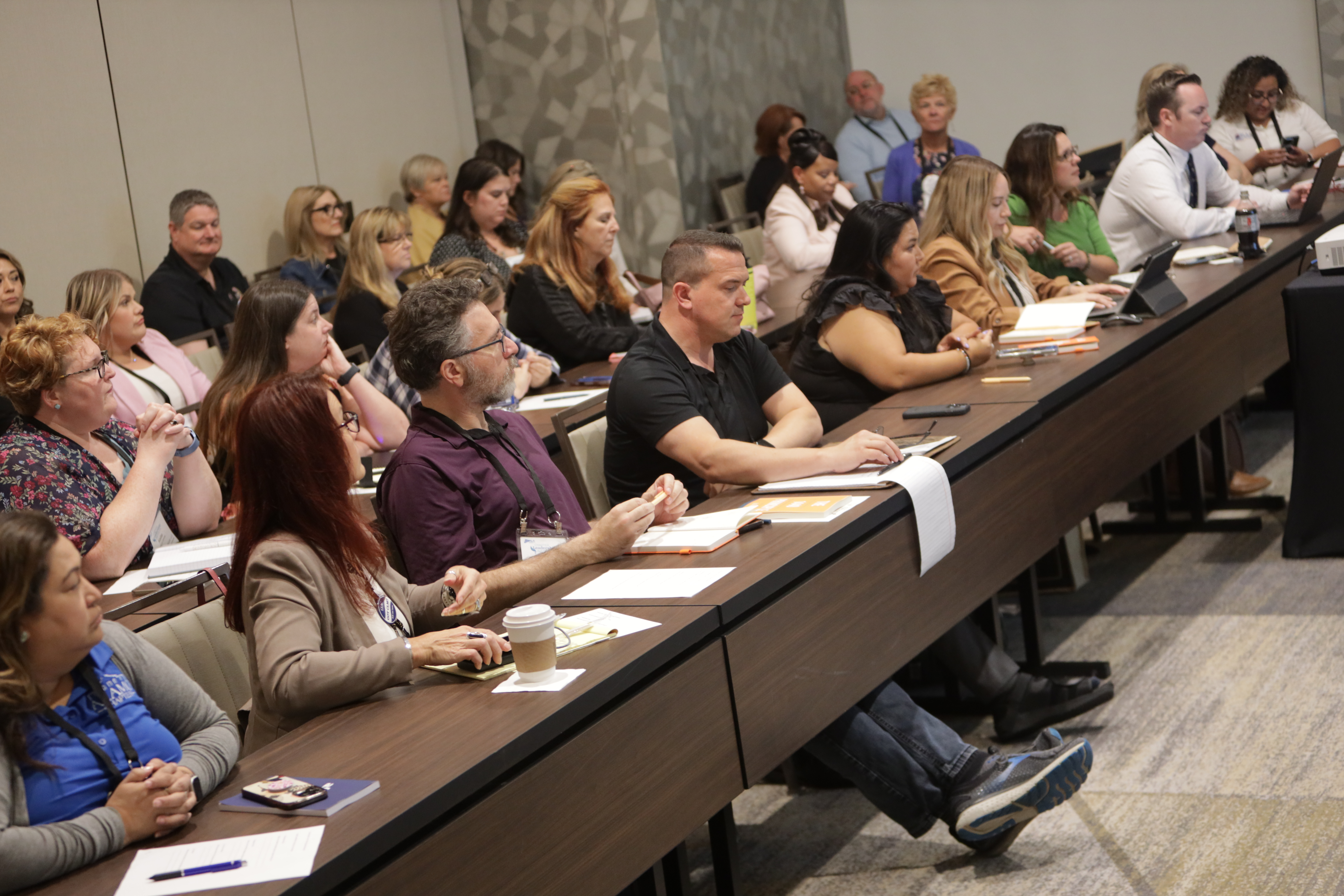 Attendees at CLI 2025 take notes at a breakout session